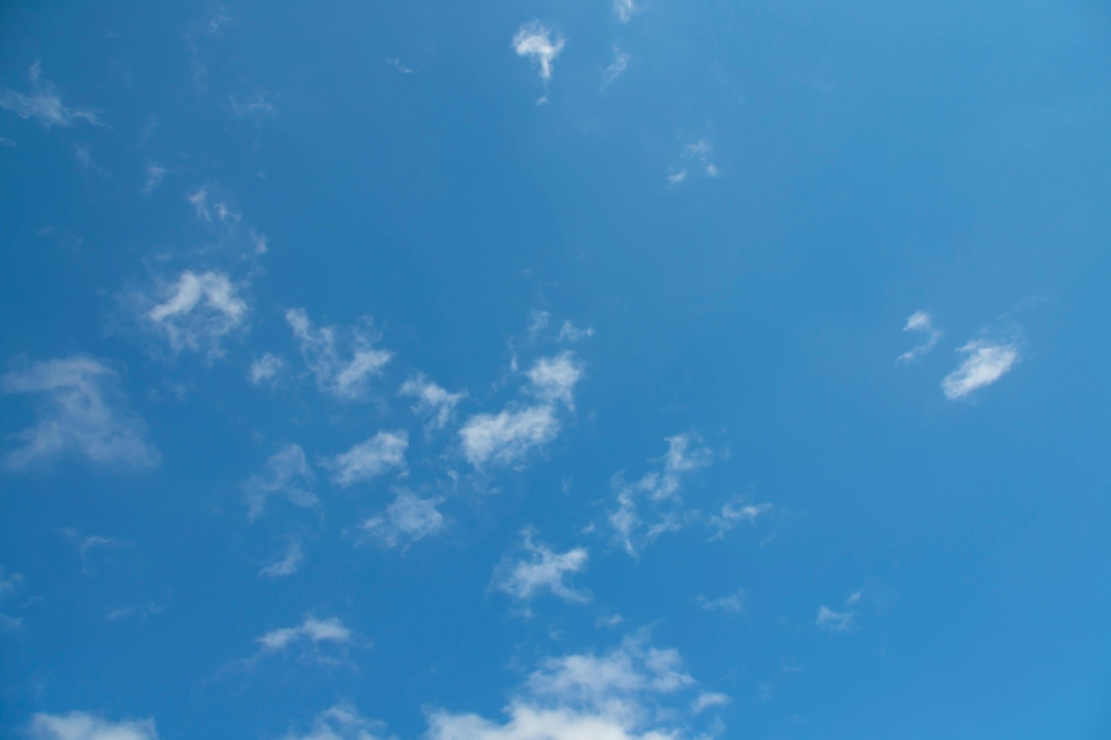 Blue sky with wispy clouds.